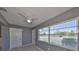 Bedroom with a ceiling fan, neutral walls, large windows, and views of the outdoors at 124 Gloucester Blvd # 355J, Sun City Center, FL 33573