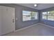 Neutral bedroom featuring two large windows providing natural light, and tile flooring at 124 Gloucester Blvd # 355J, Sun City Center, FL 33573