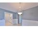 Dining room features a stylish chandelier and a view into a well-lit kitchen area at 124 Gloucester Blvd # 355J, Sun City Center, FL 33573