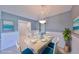 Dining room features a stylish chandelier and a well-appointed table setting at 124 Gloucester Blvd # 355J, Sun City Center, FL 33573
