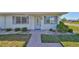 Charming home featuring a well-manicured lawn, mature landscaping, and inviting curb appeal at 124 Gloucester Blvd # 355J, Sun City Center, FL 33573