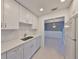 Modern kitchen featuring white cabinets, countertops, and stainless steel appliances at 124 Gloucester Blvd # 355J, Sun City Center, FL 33573