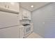 Galley kitchen featuring white cabinets and appliances, including a microwave and range at 124 Gloucester Blvd # 355J, Sun City Center, FL 33573