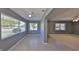Bright living room with tile flooring, large windows, and a seamless connection to adjacent spaces at 124 Gloucester Blvd # 355J, Sun City Center, FL 33573