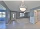 Bright living room with tile flooring, ceiling fan, and a decorative chandelier at 124 Gloucester Blvd # 355J, Sun City Center, FL 33573