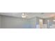 Living room with ceiling fan and view into a well-lit kitchen area at 124 Gloucester Blvd # 355J, Sun City Center, FL 33573