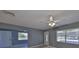 Cozy living room with a ceiling fan and two windows providing natural light at 124 Gloucester Blvd # 355J, Sun City Center, FL 33573