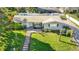 Bird's eye view of a home with a manicured lawn, walkway, and a freshly painted gray exterior at 1247 Holiday Dr, Tarpon Springs, FL 34689