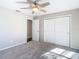 Bedroom with carpeted floors, ceiling fan, large closet, and an entryway at 1247 Holiday Dr, Tarpon Springs, FL 34689