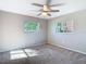 Neutral bedroom with a ceiling fan and two windows providing natural light at 1247 Holiday Dr, Tarpon Springs, FL 34689