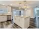 Bright kitchen with stainless appliances, granite counters, island, and seamless access to outdoor living space, ideal for entertaining at 1247 Holiday Dr, Tarpon Springs, FL 34689