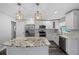 Modern kitchen with stainless steel appliances, granite countertops and white cabinetry at 1247 Holiday Dr, Tarpon Springs, FL 34689