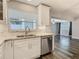 Kitchen sink with stainless steel appliances, tile backsplash, and natural lighting at 1247 Holiday Dr, Tarpon Springs, FL 34689