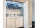 Washer and dryer with built in wire shelving in laundry room at 1247 Holiday Dr, Tarpon Springs, FL 34689
