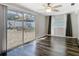 Bright room featuring sliding glass doors to a backyard patio and modern ceiling fan at 1247 Holiday Dr, Tarpon Springs, FL 34689