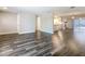Open-concept living area showcasing modern flooring, connecting seamlessly to the kitchen, creating an ideal space for entertaining at 1247 Holiday Dr, Tarpon Springs, FL 34689