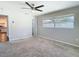 Spacious living room with carpet and large window with backyard views at 1247 Holiday Dr, Tarpon Springs, FL 34689