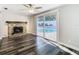 Living room with a brick fireplace and sliding doors to a backyard pool area at 1247 Holiday Dr, Tarpon Springs, FL 34689