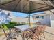 Patio with table, chairs, and a view of the yard at 1247 Holiday Dr, Tarpon Springs, FL 34689