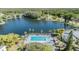 Scenic aerial view of the pool and lake in a beautiful community setting at 1333 Shady Pine Way # B, Tarpon Springs, FL 34688