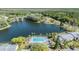 Scenic aerial view of the pool and lake in a beautiful community setting at 1333 Shady Pine Way # B, Tarpon Springs, FL 34688