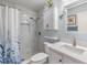 A beautifully renovated bathroom with a modern vanity and a glass shower with mosaic tile at 1333 Shady Pine Way # B, Tarpon Springs, FL 34688