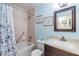Bathroom featuring a shower-tub combination, vanity, and light blue walls at 1333 Shady Pine Way # B, Tarpon Springs, FL 34688