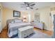 Comfortable bedroom with ceiling fan, artwork, and a white dresser at 1333 Shady Pine Way # B, Tarpon Springs, FL 34688