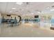 Bright and spacious clubhouse with tables, chairs, and ample natural light for community gatherings at 1333 Shady Pine Way # B, Tarpon Springs, FL 34688