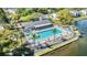Inviting community pool and clubhouse with lounge chairs and a serene lake backdrop at 1333 Shady Pine Way # B, Tarpon Springs, FL 34688