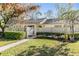 Charming townhome featuring a well-manicured lawn and walkway, providing an inviting entrance and enhanced curb appeal at 1333 Shady Pine Way # B, Tarpon Springs, FL 34688