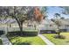 Charming home featuring a well-maintained lawn, mature tree, and a cozy, inviting entrance at 1333 Shady Pine Way # B, Tarpon Springs, FL 34688
