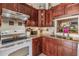 Close up of kitchen with granite counters, stainless steel sink, and wood cabinets at 1333 Shady Pine Way # B, Tarpon Springs, FL 34688