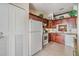 Bright kitchen with wood cabinetry, granite countertops, and modern appliances at 1333 Shady Pine Way # B, Tarpon Springs, FL 34688