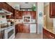 Kitchen with stainless steel sink, granite countertops, and wooden cabinetry at 1333 Shady Pine Way # B, Tarpon Springs, FL 34688