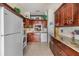 Bright kitchen featuring granite countertops, tiled floor, and appliances at 1333 Shady Pine Way # B, Tarpon Springs, FL 34688