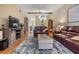 A spacious living room features vaulted ceilings, stylish furniture, and wood-look flooring at 1333 Shady Pine Way # B, Tarpon Springs, FL 34688