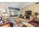 Comfortable living room with a large sliding glass door and entertainment center at 1333 Shady Pine Way # B, Tarpon Springs, FL 34688