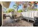 Cozy patio with brick pavers, a privacy fence, and outdoor furniture, creating a relaxing outdoor space for leisure activities at 1333 Shady Pine Way # B, Tarpon Springs, FL 34688