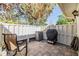 Private brick patio with a grill, storage container, and privacy fence offering a great outdoor living space for entertaining at 1333 Shady Pine Way # B, Tarpon Springs, FL 34688