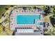 Aerial view of a sparkling community pool with lounge chairs and well-maintained deck at 1333 Shady Pine Way # B, Tarpon Springs, FL 34688