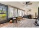 Bright sunroom with tile floors, ceiling fan, and a view of the outdoors, perfect for relaxing and enjoying the natural light at 1333 Shady Pine Way # B, Tarpon Springs, FL 34688