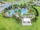 Overhead view of community pool with palm trees, lounge chairs, and a gazebo seating area at 14885 Caravan Ave, Odessa, FL 33556