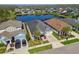 This stunning home boasts beautiful landscaping, a driveway, and breathtaking views of the water and neighborhood at 14885 Caravan Ave, Odessa, FL 33556