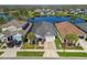 Lovely home features a manicured lawn, driveway, and a gorgeous water view in a tranquil neighborhood at 14885 Caravan Ave, Odessa, FL 33556