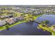 Beautiful aerial view of backyard of home, lake, and bridge with serene water views in a desirable community at 14885 Caravan Ave, Odessa, FL 33556
