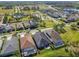 Gorgeous aerial view of the neighborhood featuring well-maintained homes, mature trees, and neighborhood amenities at 14885 Caravan Ave, Odessa, FL 33556
