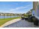 Paver patio features comfortable seating and lake views at 14885 Caravan Ave, Odessa, FL 33556