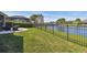 Fenced backyard with lake view and wrought iron fence at 14885 Caravan Ave, Odessa, FL 33556