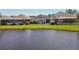 Beautiful backyard view of home with patio, lush green lawn and serene water views, perfect for relaxation and entertaining at 14885 Caravan Ave, Odessa, FL 33556